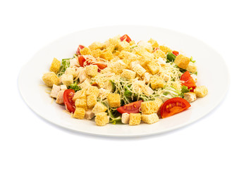 salad of different ingredients on a white plate on a wooden background