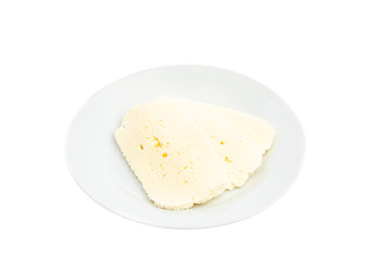 sliced white cheese on a white plate isolated