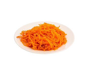 korean carrot as a salad sliced in strips on a white plate isolated