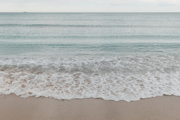 Waves of the Mediterranean Sea on the beach in the afternoon