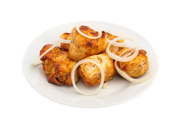 chicken breast skewers with onions on a white plate isolated