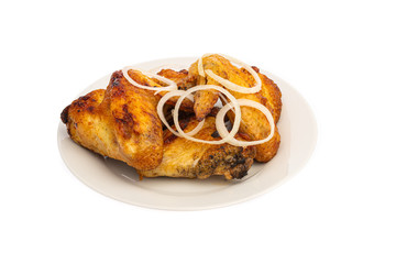 grilled chicken wings on a white plate with onion isolated