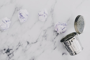 reative block or burnout, group of scrunched paper ball drafts going into garbage bin