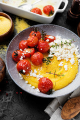Homemade polenta with grilled cherry tomatoes and ricotta cheese.