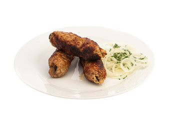 baked on a skewer grill meat long cutlet on a white plate with onions and herbs isolated