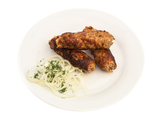 baked on a skewer grill meat long cutlet on a white plate with onions and herbs isolated