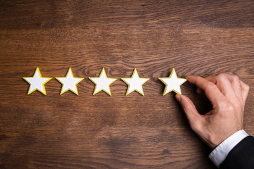 Person Placing Five Star Rating Icon