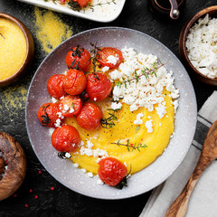 Homemade polenta with grilled cherry tomatoes and ricotta cheese.