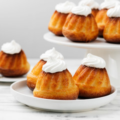 Homemade  dessert rum baba decorated with whipped cream.