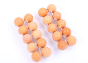 Tray of raw eggs isolated on a white background