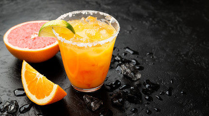 Refreshing summer alcoholic cocktail margarita with crushed ice and citrus fruits.