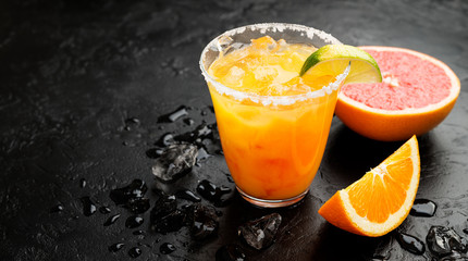 Refreshing summer alcoholic cocktail margarita with crushed ice and citrus fruits.