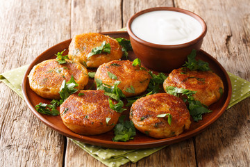 Street food of India. Potato Aloo Tikki served with yogurt closeup in a plate. horizontal