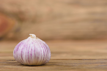 Head of garlic on a wooden background.
