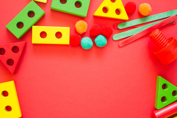 Kids lay Flat. children's toys frame on a red background. Concept of development and education of children. designer, sorter, creativity. the view from the top. Leisure and Hobbies of the child.