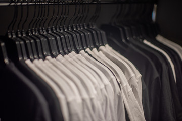 Fototapeta premium Clothing hanging on railing for display in store