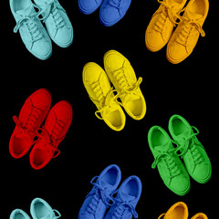 Short low brigt sneakers on a black background. Rainbow. Seamless pattern	