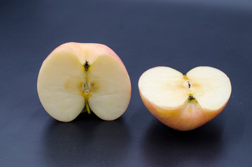 The cut red apple on the black background