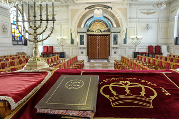 Holy book and menorah on altar in Moroccan synagogue. - obrazy, fototapety, plakaty