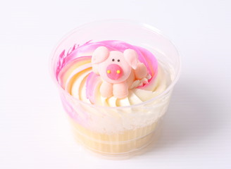 A colorful cupcake with doll on top , isolated