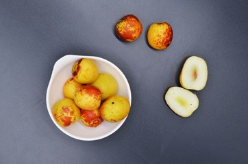 Dates cut in a white plate on a black background