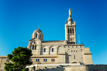 Beautiful view of Notre Dame in Marseille against a clear blue sky.