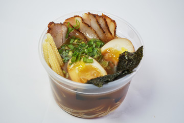 Asian soup in a bowl for delivery on a white background

