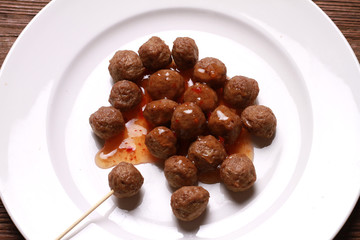 fried meat ball and sauce on white dish