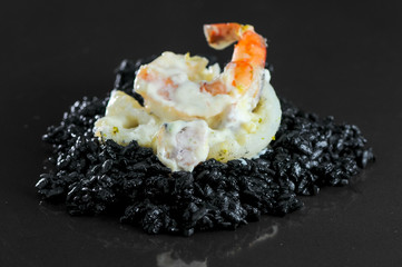  black rice risotto with seafood  decorated with scallop