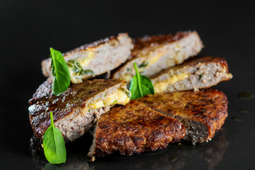 beef steak with cheese on a black glossy background