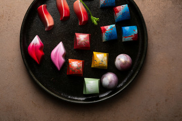 Overhead view of Collection of  Chocolate candy on dark tray