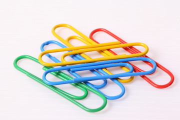 colorful paper clips over the white background