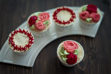 Beautiful cup cakes flowers from butter cream, in red and pink colour. Suitable for Birthday, Anniversary, Valentine Day and festive. selective focus