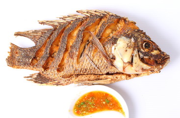 Fried fish isolated with spicy sauce in white background