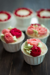 Beautiful cup cakes flowers from butter cream, in red and pink colour. Suitable for Birthday, Anniversary, Valentine Day and festive. selective focus