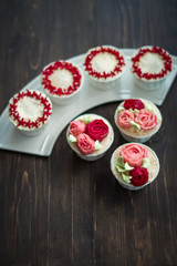 Beautiful cup cakes flowers from butter cream, in red and pink colour. Suitable for Birthday, Anniversary, Valentine Day and festive. selective focus