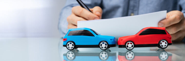 Close-up Of Two Blue And Red Wooden Car