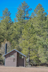 A park bathroom / outhouse equipped for male, female and handicap accessible. Timber Camp in Globe, Gila County, Tonto National Forest, Arizona USA