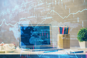 Financial market graph hologram and personal computer on background. Double exposure. Concept of forex.