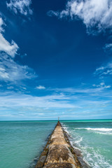 Breakwater on sunny day vertical shot