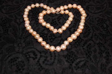 Heart made of pearls on a black background. Heart made of beads. Heart for valentines day.