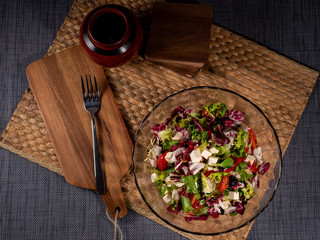 fresh salad in bowl on table in kitchen. View from the top.
