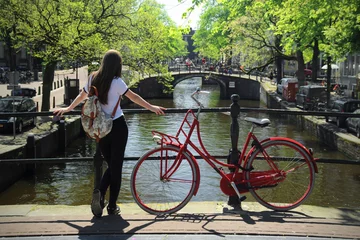Poster de jardin Amsterdam young woman with bicycle