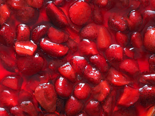 dessert - chopped strawberries in strawberry jelly as texture and background