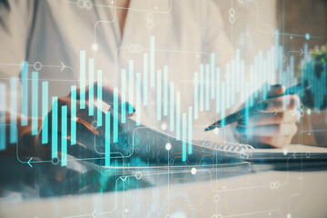 Financial chart drawn over hands taking notes background. Concept of research. Multi exposure