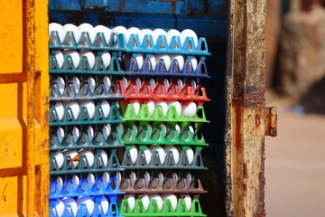 Naklejka premium close-up of white huns egg on red,green, purple and blue tray on street market place