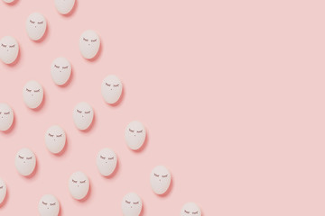 Happy Easter. Pattern with white eggs with painted eyes on pink background. Flat lay, top view, copy space.
