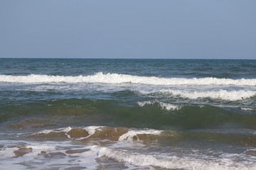 close up of the blue sea with white water wave and clear blue sky backgrounds