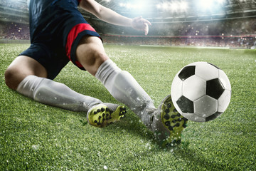 Football scene with competing football players at the stadium