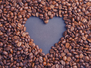 Heart coffee frame made of coffee beans on burlap texture